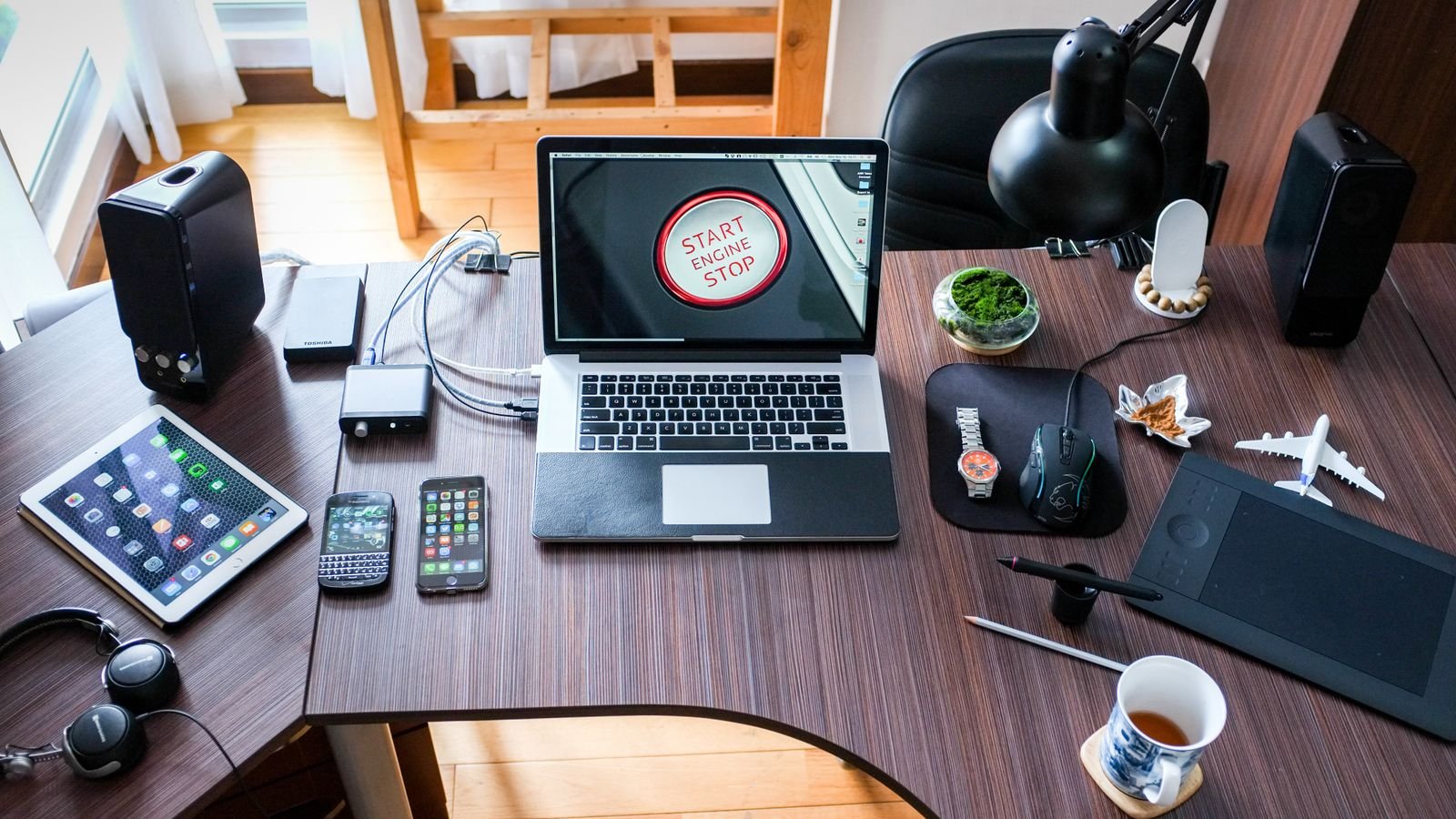 A contemporary office desk setup with laptops and gadgets, representing quantum computing research moving toward commercial applications