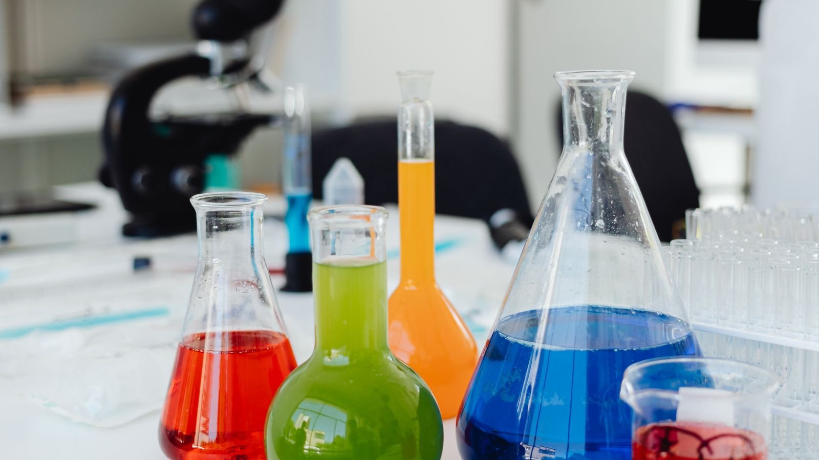 Colorful laboratory glassware with liquid solutions, representing quantum computing research and scientific breakthroughs