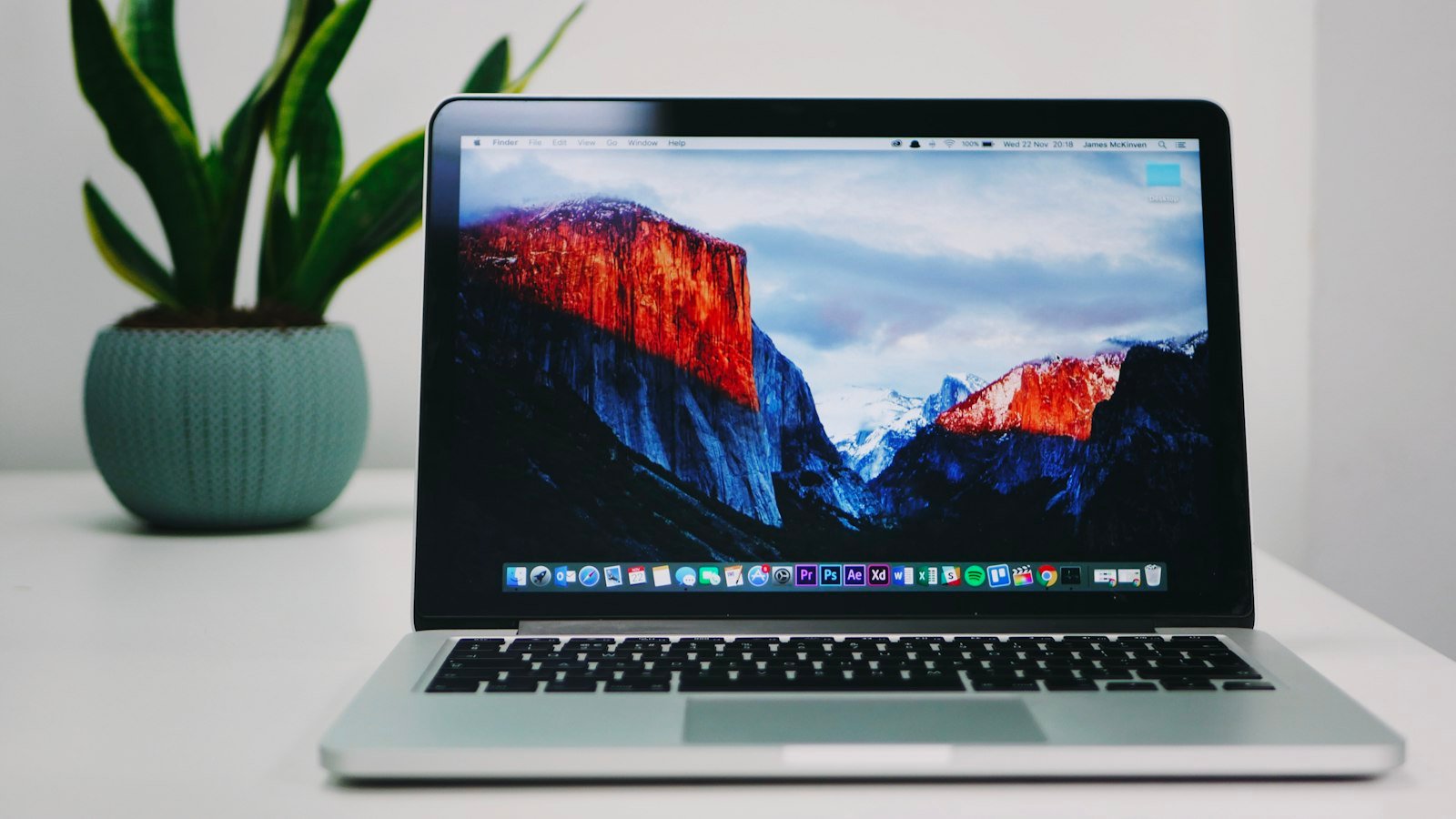 Silver laptop open on a desk, representing Apple's upcoming MacBook lineup