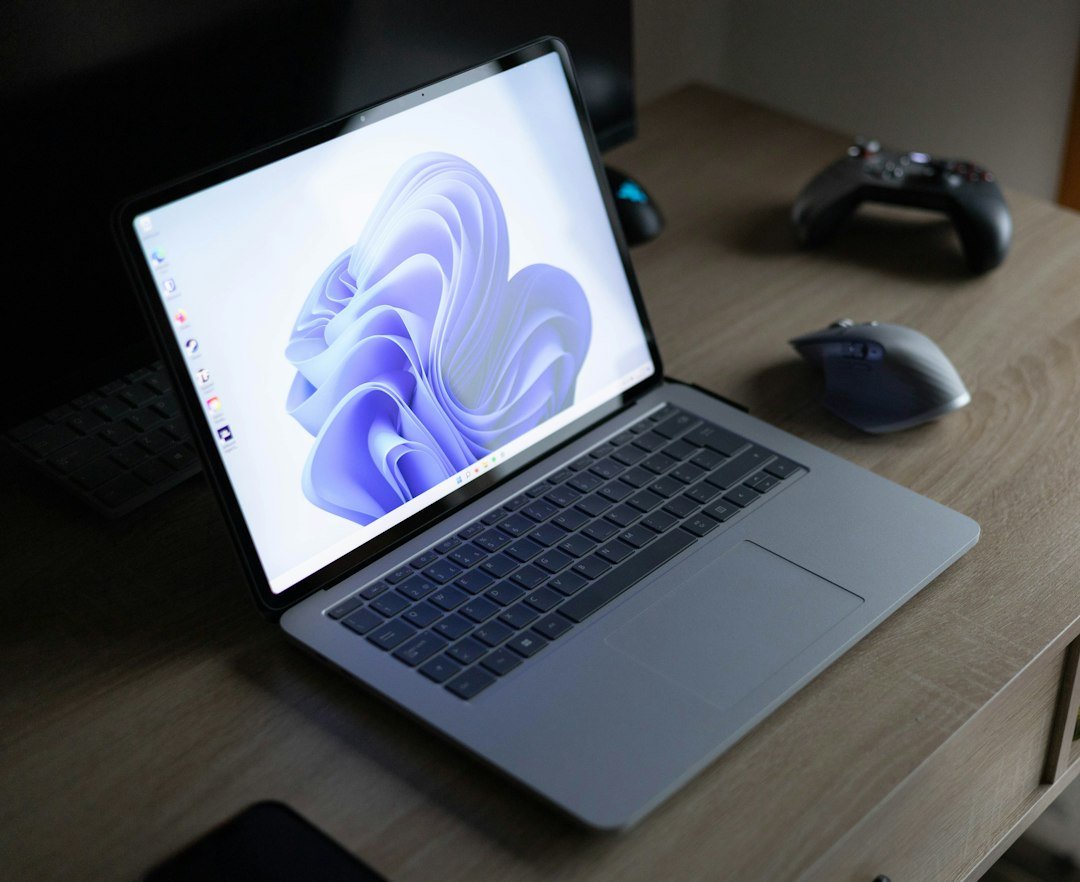 A laptop computer sitting on a wooden desk