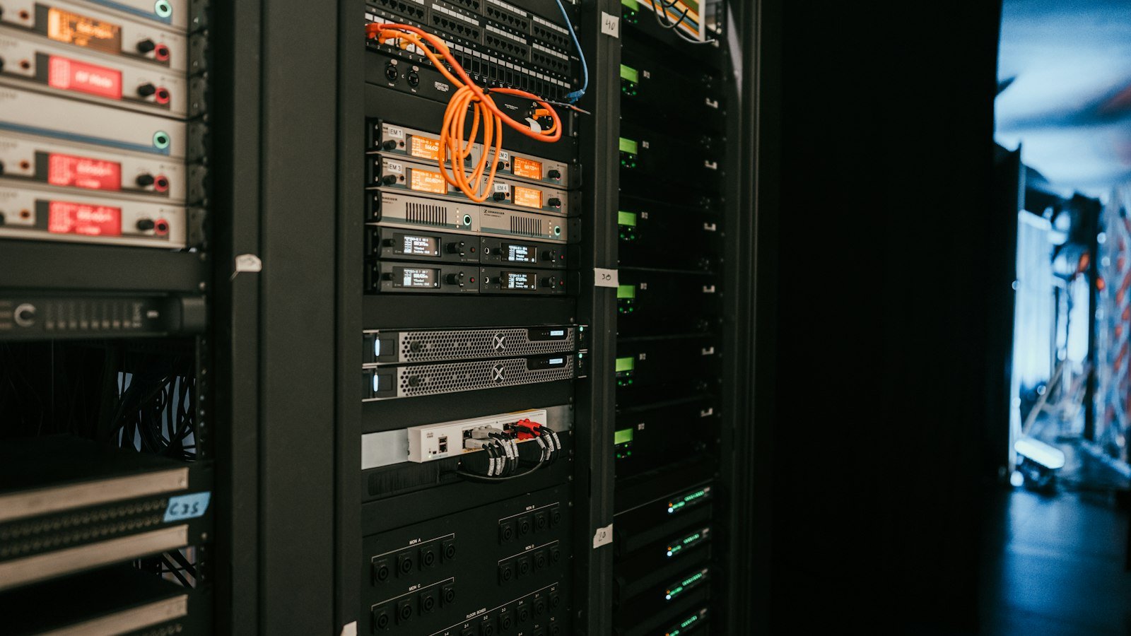 A rack of servers in a server room, representing AI infrastructure funding