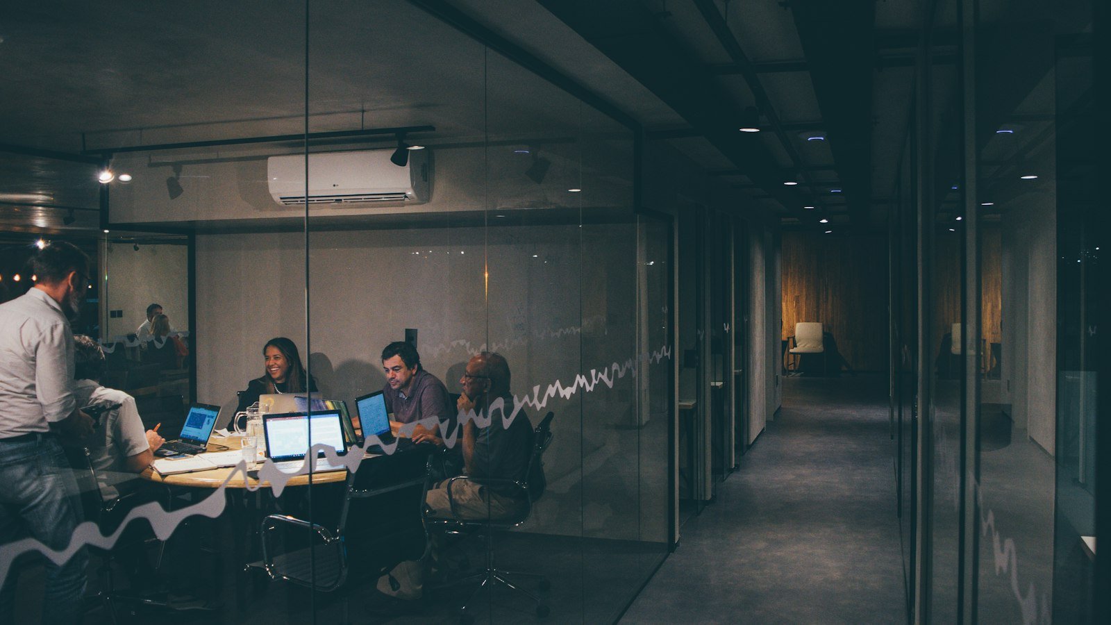 Group of people having a meeting around a table, representing venture capital and startup funding decisions